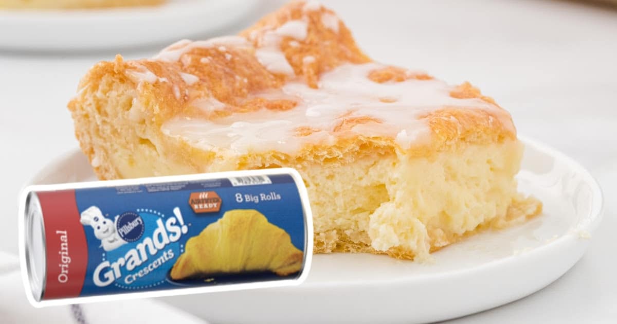 Cheese danish slice lifted from pan on a spatula showing golden brown layers and creamy cheese filling.