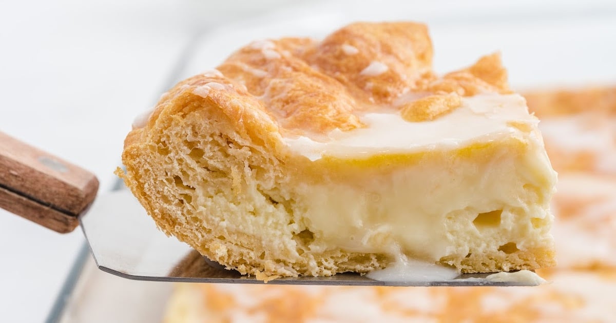 Flat lay of labeled cheese danish ingredients including crescent rolls, cream cheese, eggs, vanilla, sugar, and lemon juice.