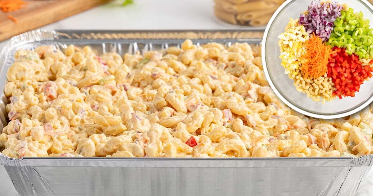 Large foil pan of creamy macaroni salad, with an inset image of fresh diced vegetables and pasta before mixing.