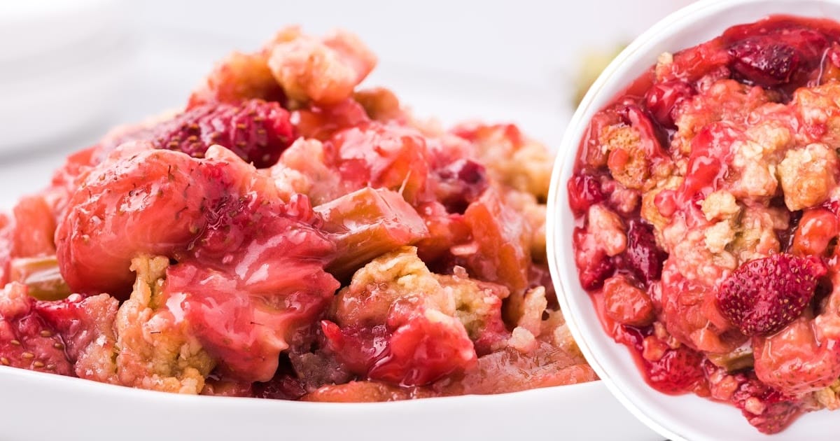Side-by-side view of rhubarb strawberry crisp on a plate and in a bowl, both full of juicy red fruit and crumb topping.