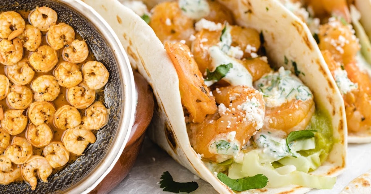 Side-by-side close-up of shrimp tacos and a skillet full of cooked shrimp in sauce, highlighting the contrast of fresh taco fillings and juicy cooked shrimp.