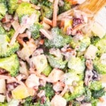 Broccoli Apple Salad in a bowl with a wooden spoon in it