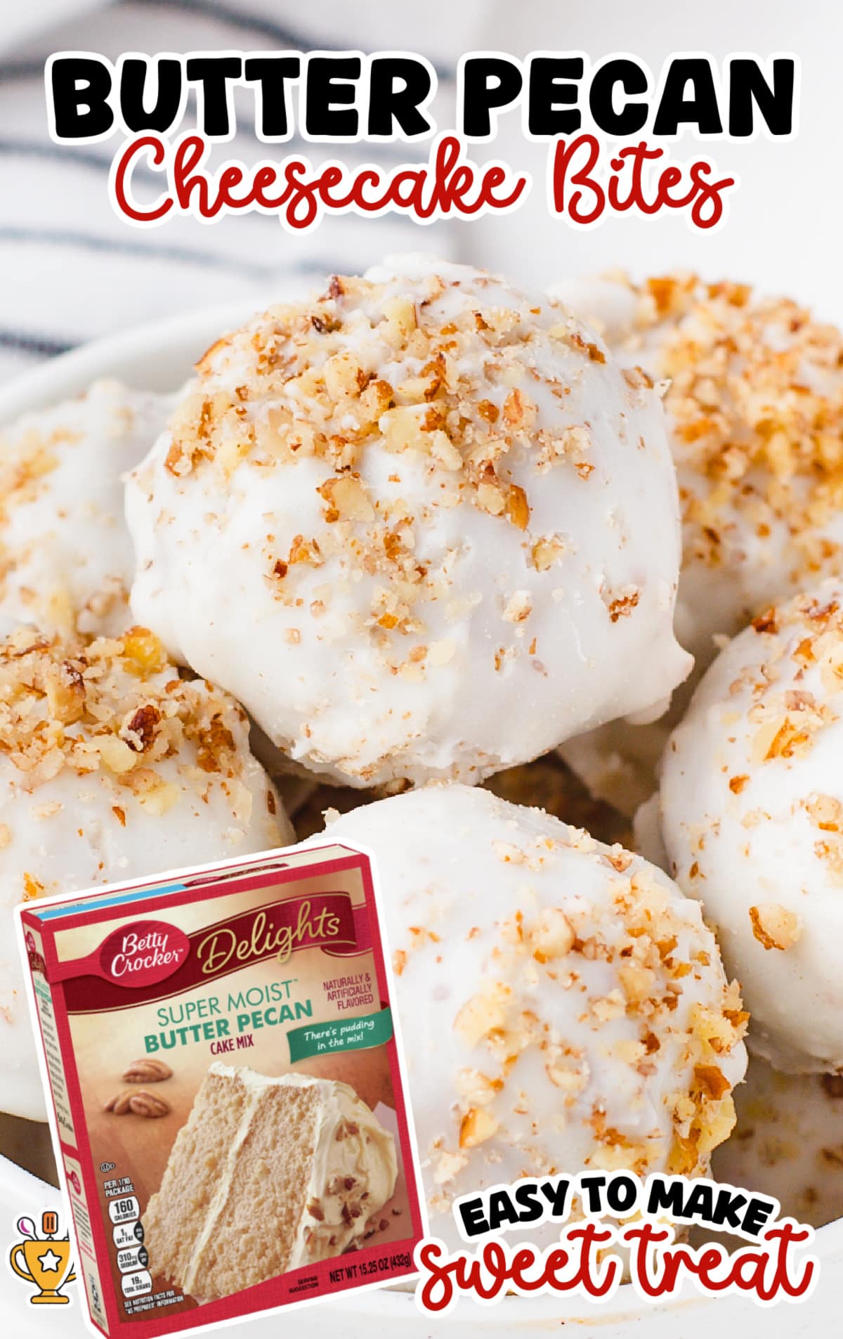 Close-up of white chocolate-coated butter pecan cheesecake bites topped with crushed pecans, arranged in a bowl with a box of Betty Crocker Super Moist Butter Pecan Cake Mix in the foreground.