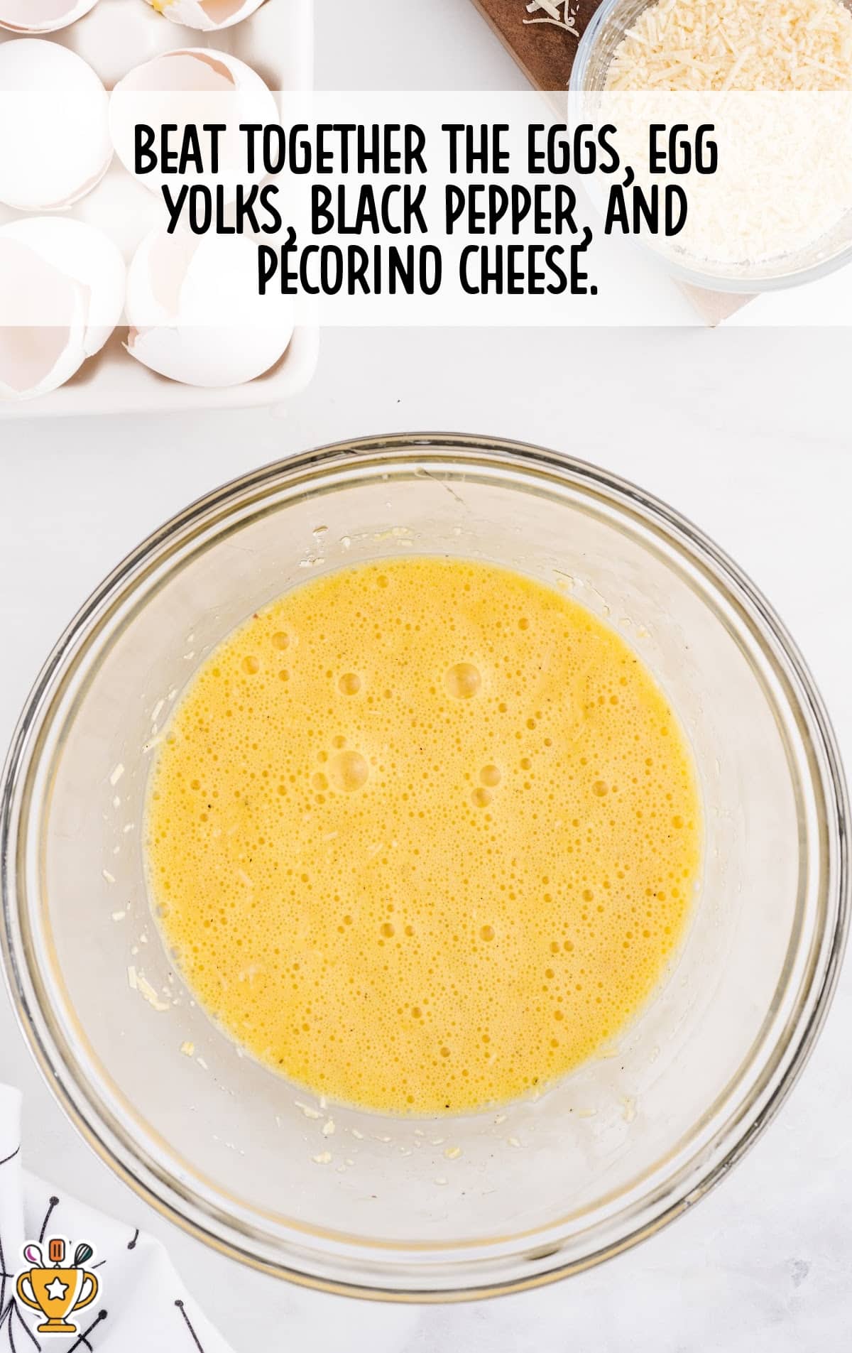 eggs, egg yolks, black pepper and pecorino cheese mixed in a bowl