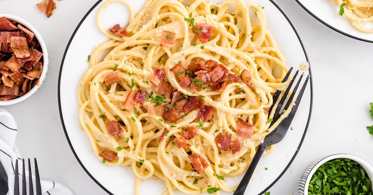 Carbonara Pasta in a bowl pate with a fork