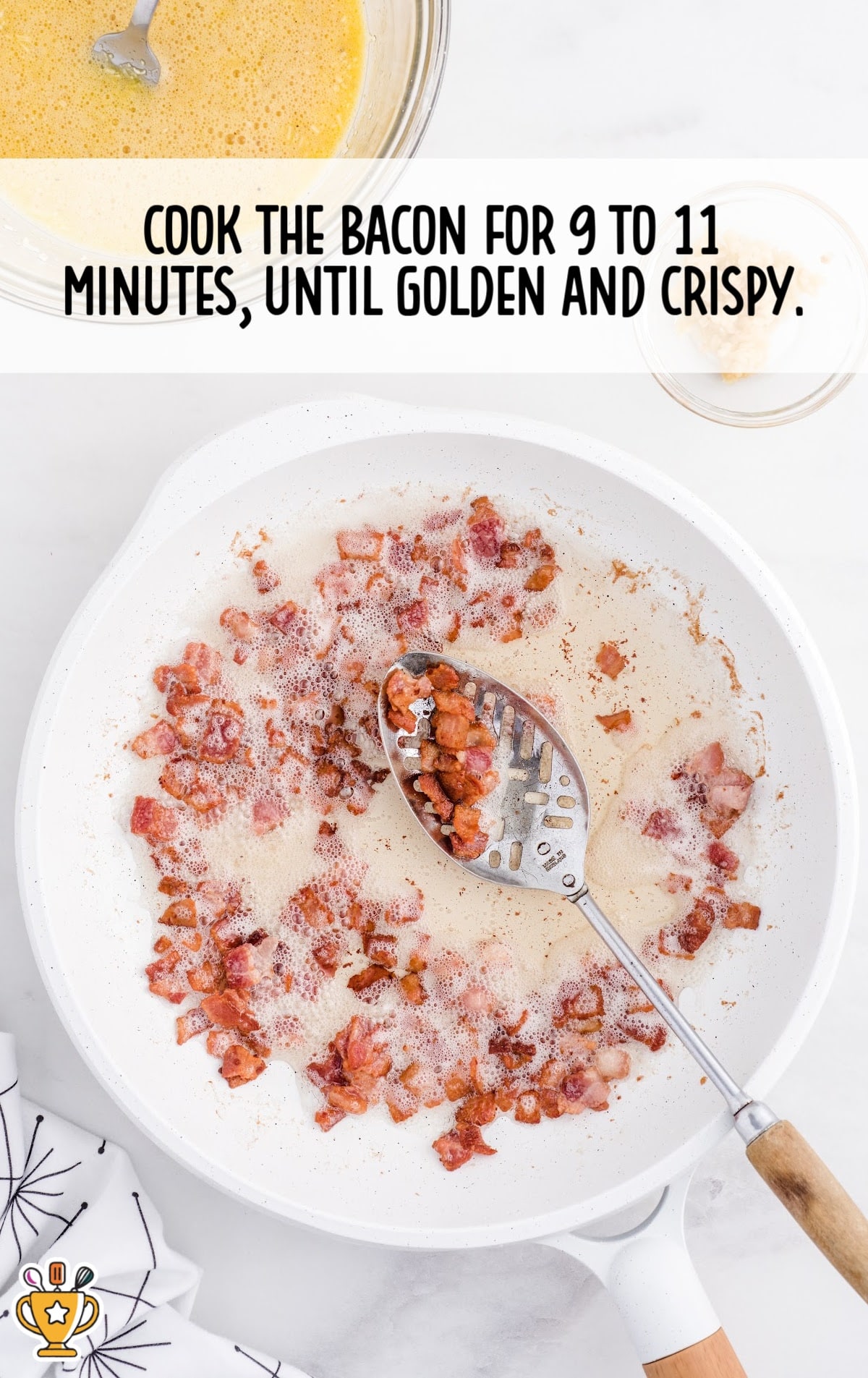 cooking some bacon in a white skillet with a spoon
