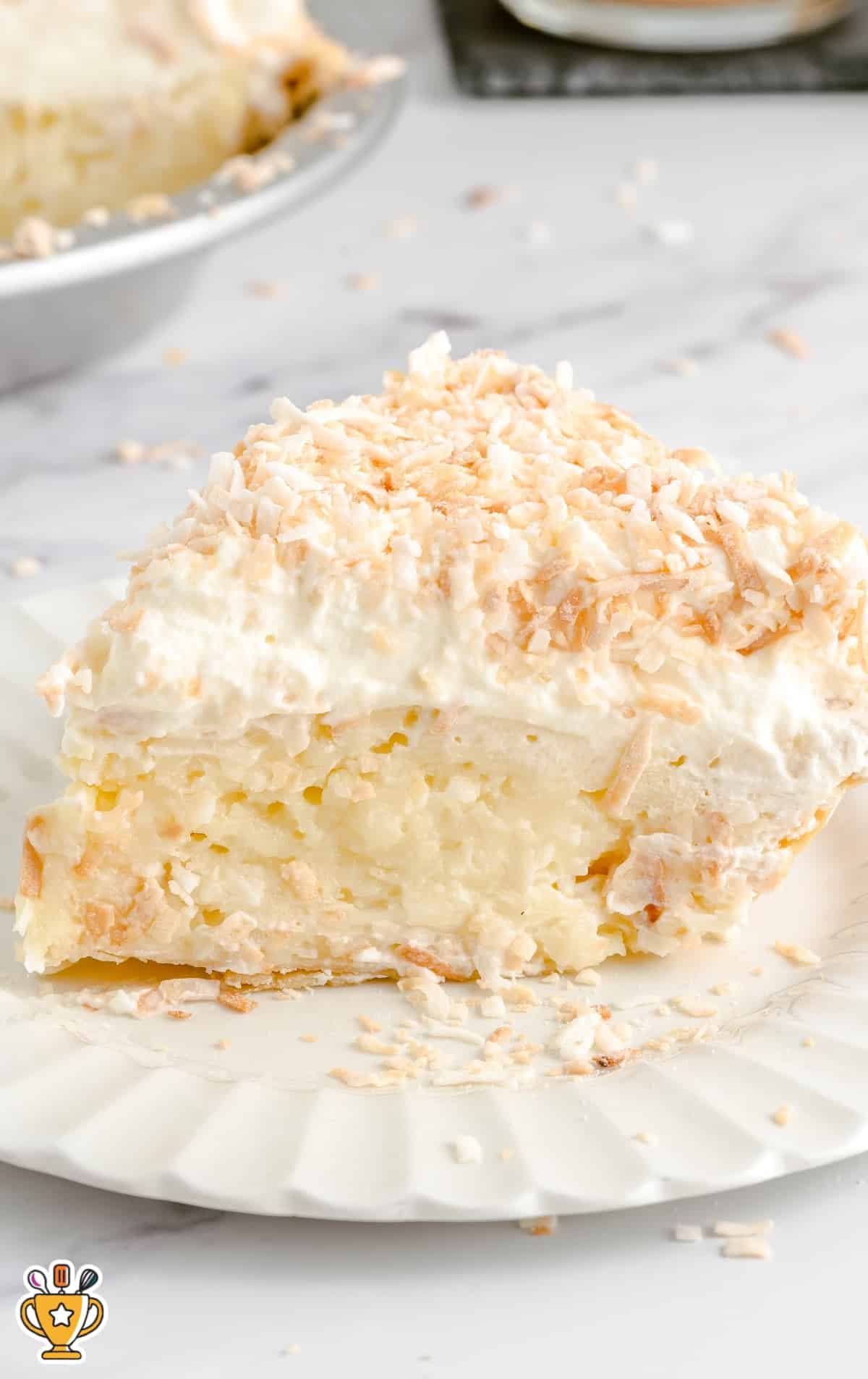 Close-up view of a sliced coconut cream pie showing creamy filling and crust layers.