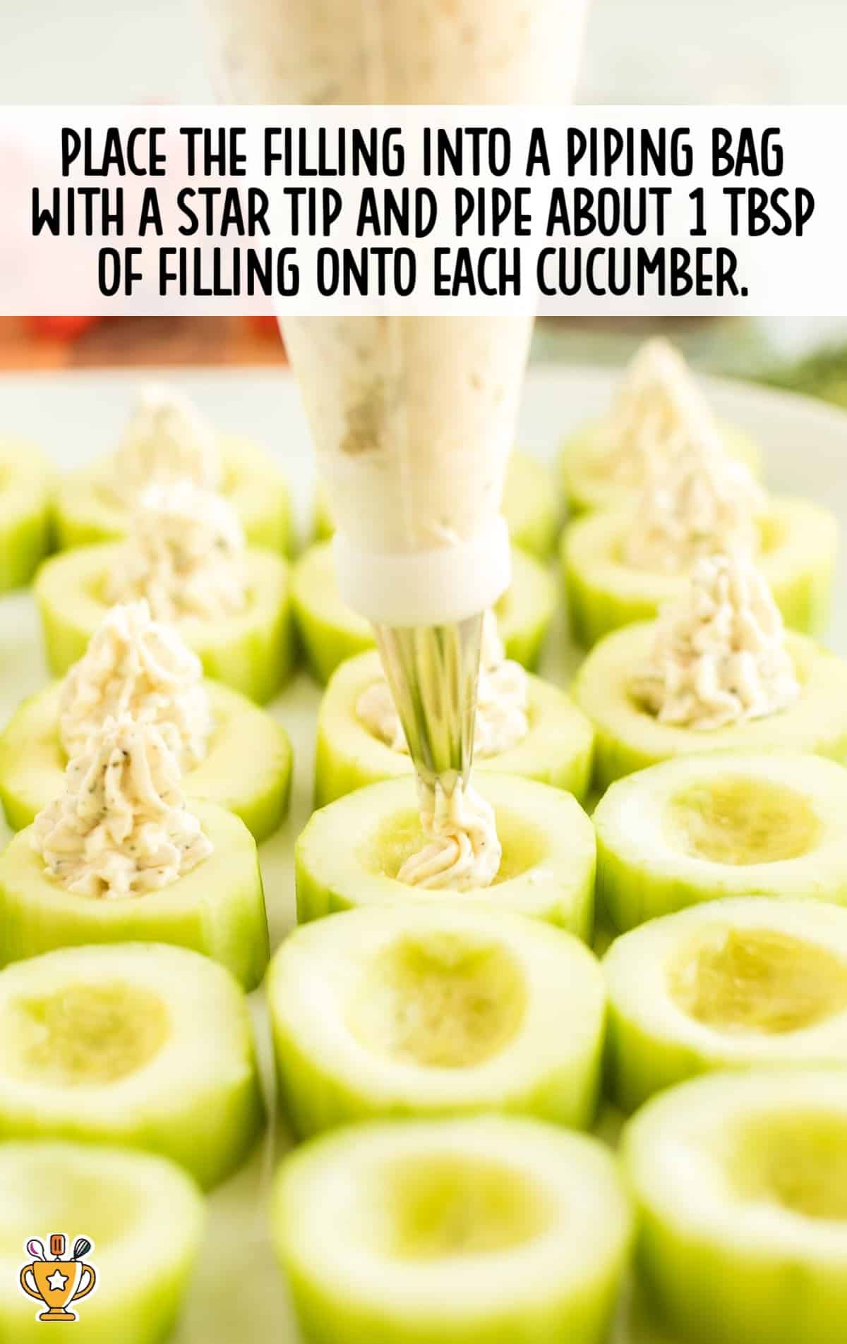 Piping creamy filling into the hollowed center of cucumber slices using a star-tip piping bag for a pretty presentation.