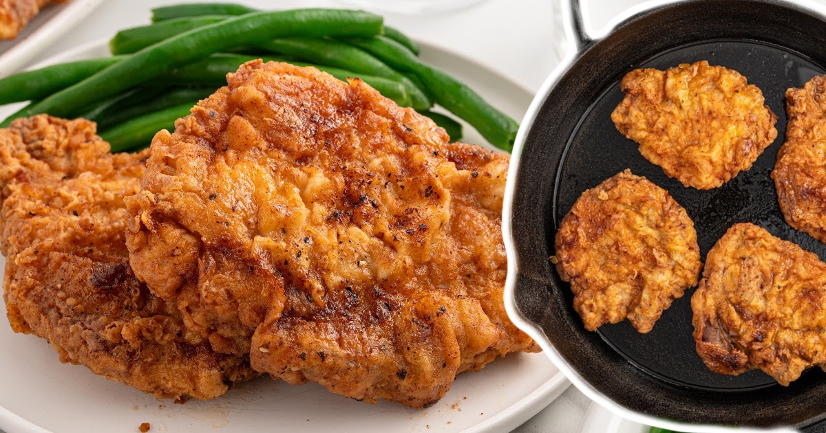 A beautifully fried pork chop cut open to reveal its tender, juicy interior, with the crispy exterior visible, accompanied by green beans.