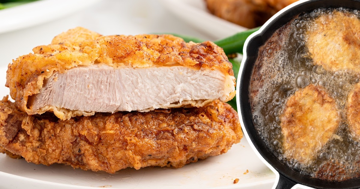 A plate of fried pork chops stacked on top of each other, golden and crispy on the outside, with a side of green beans.