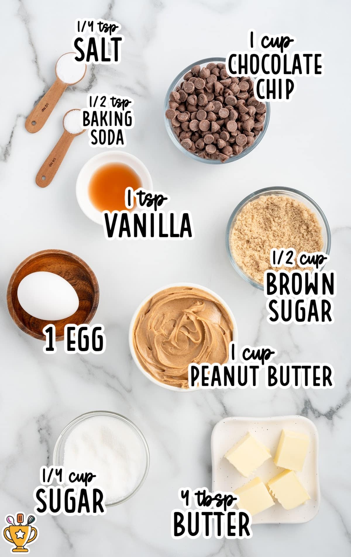 A flat lay of ingredients for gluten-free chocolate chip cookies, including brown sugar, chocolate chips, peanut butter, an egg, and baking soda. All ingredients are measured out in bowls and laid on a white marble surface.