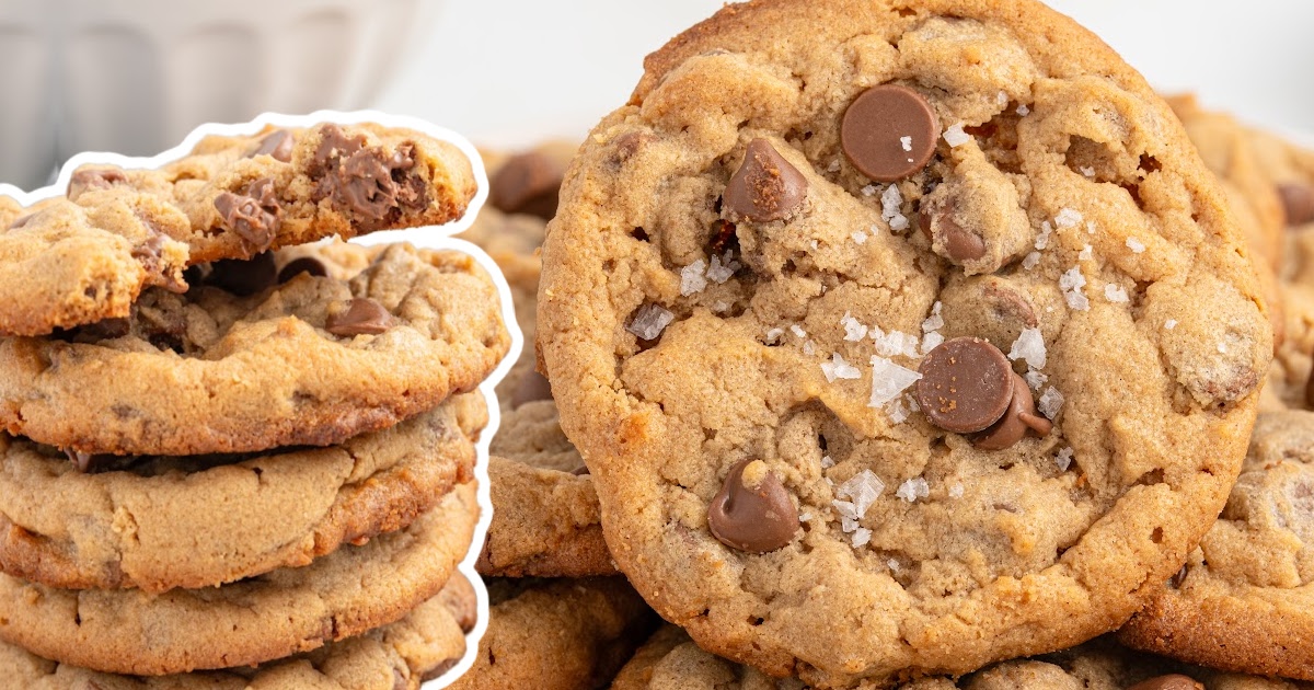 A close-up of gluten-free chocolate chip cookies stacked high, with some pieces slightly broken to reveal the gooey center. The image shows the golden brown color and chocolate chip texture.