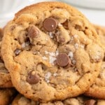 A playful image showing a stack of golden brown gluten-free chocolate chip cookies. The image includes text that reads, “So Soft and So Sweet!” with a smaller image of chocolate chips and peanut butter next to the stack of cookies.