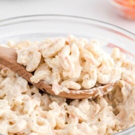 a bowl of Hawaiian Macaroni Salad with a wooden spoon in it