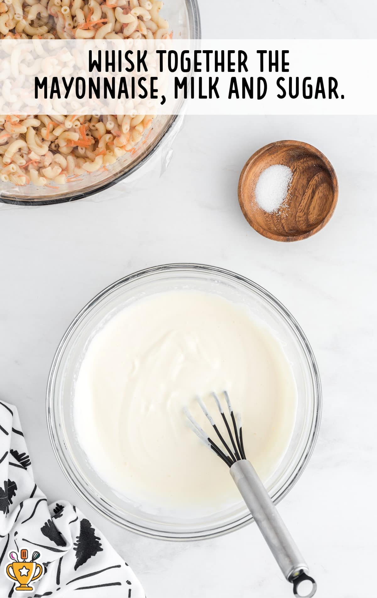 whisking together mayonnaise, milk and sugar in a bowl