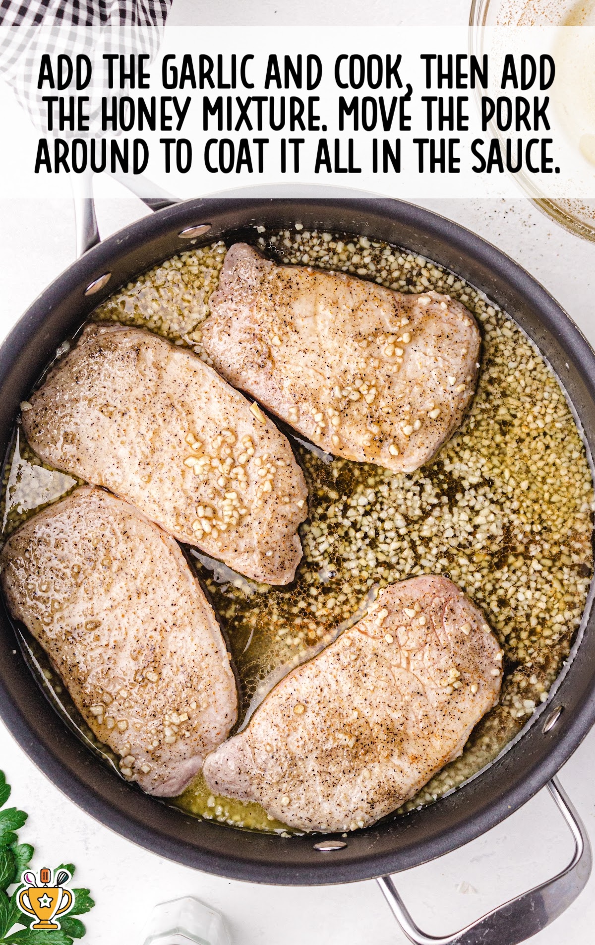 garlic and honey added into the skillet with the pork
