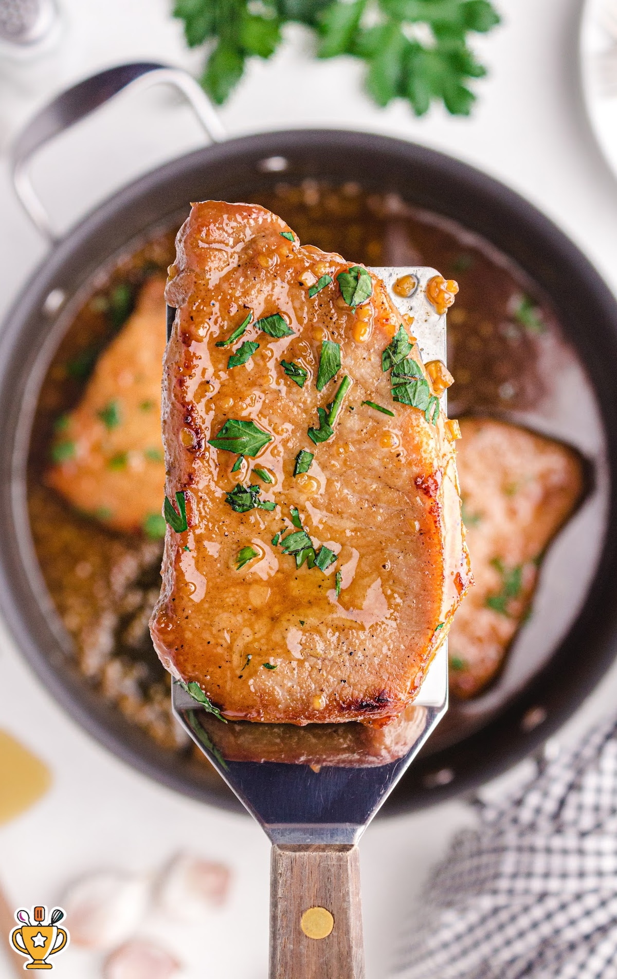 a spatula holding a Honey Garlic Pork Chop
