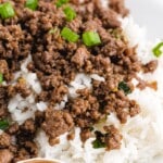 Korean Beef served with white rice on a white plate, a bowl of Korean Beef served with white rice on the side