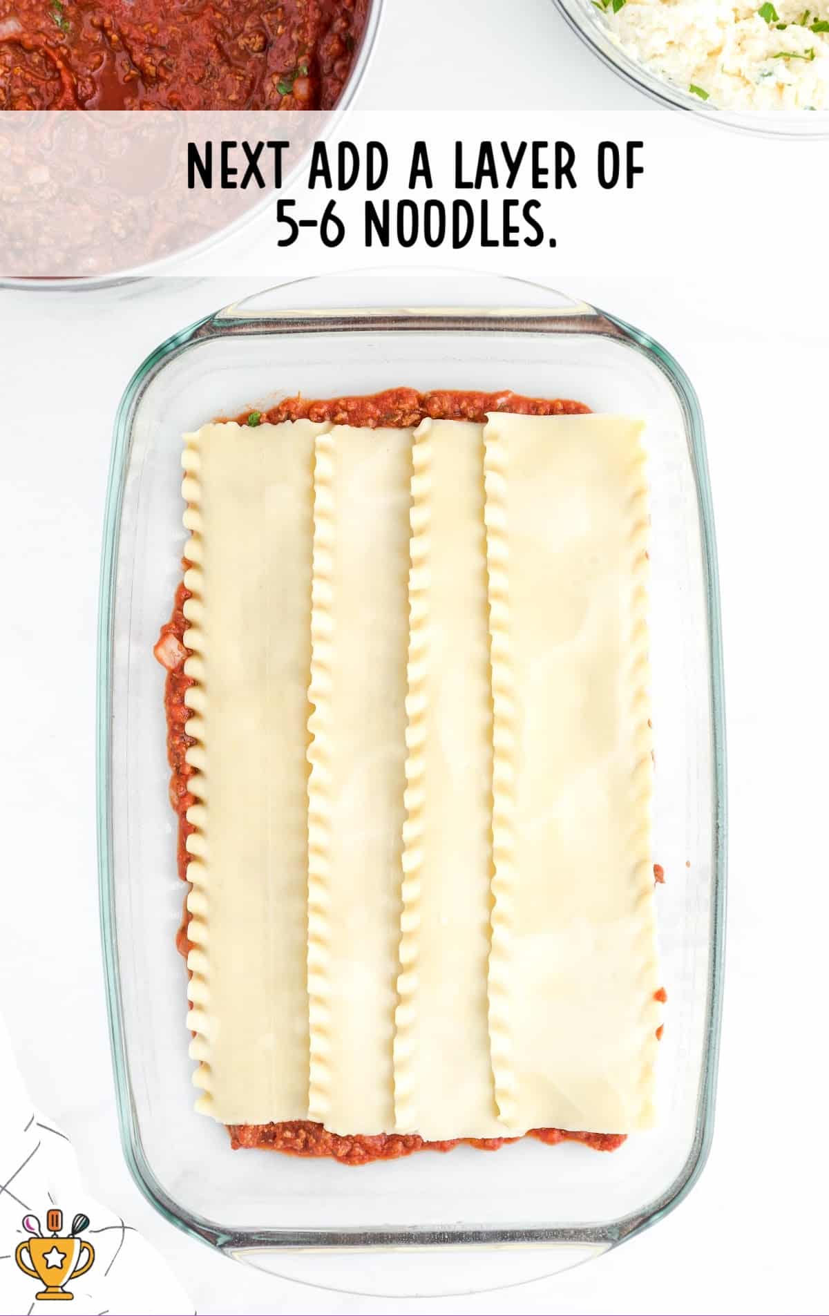 layers of noodles added in a baking dish