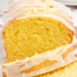 a whole lemon pond cake with two cut slices