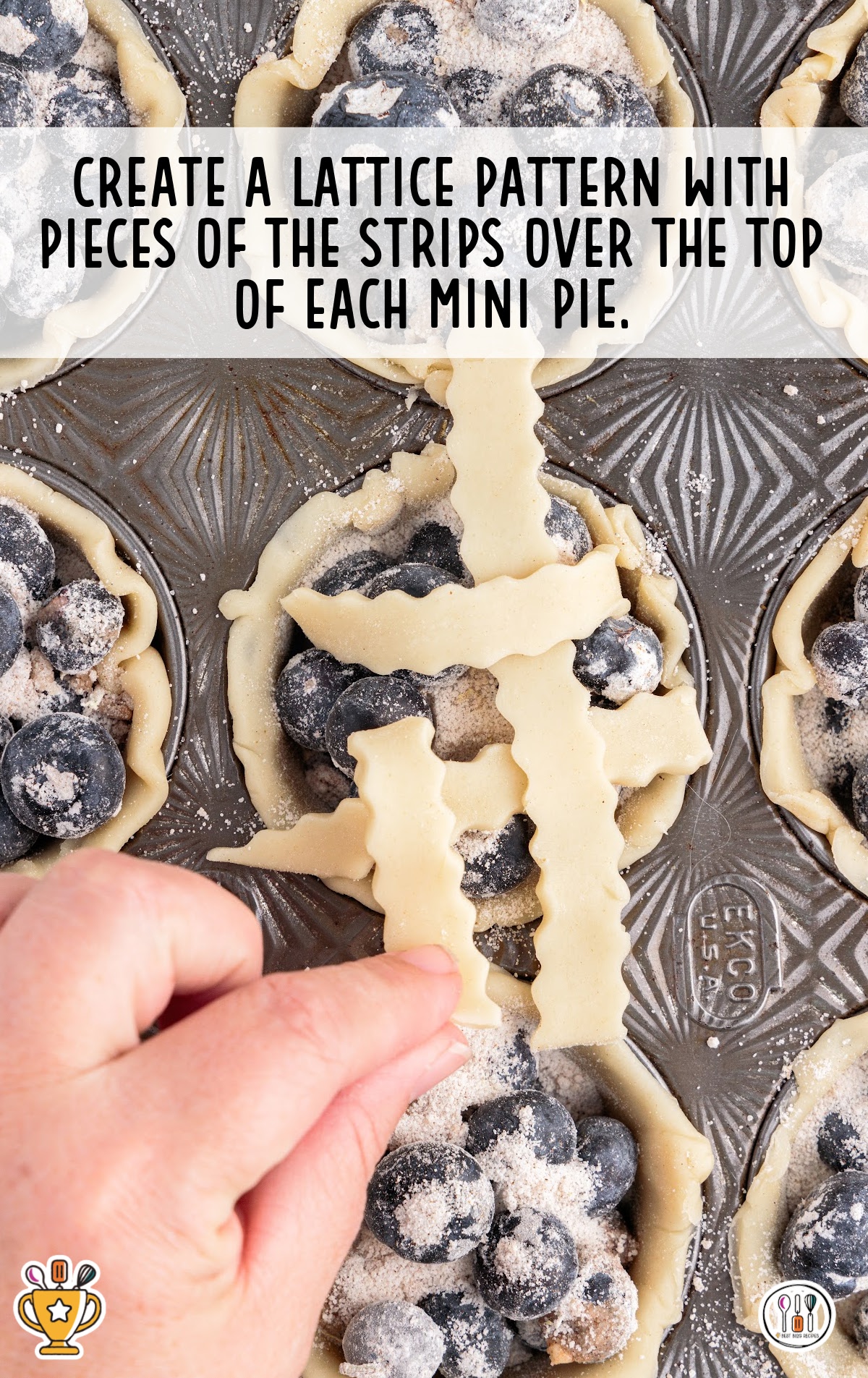 Close-up of fingers placing lattice strips over the top of the filled mini pies to create a criss-cross pattern.
