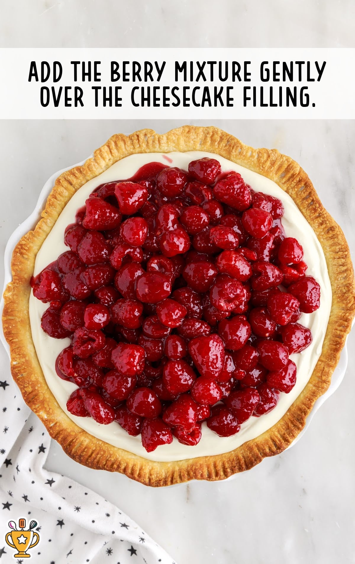adding the berry mixture over the cheesecake filling