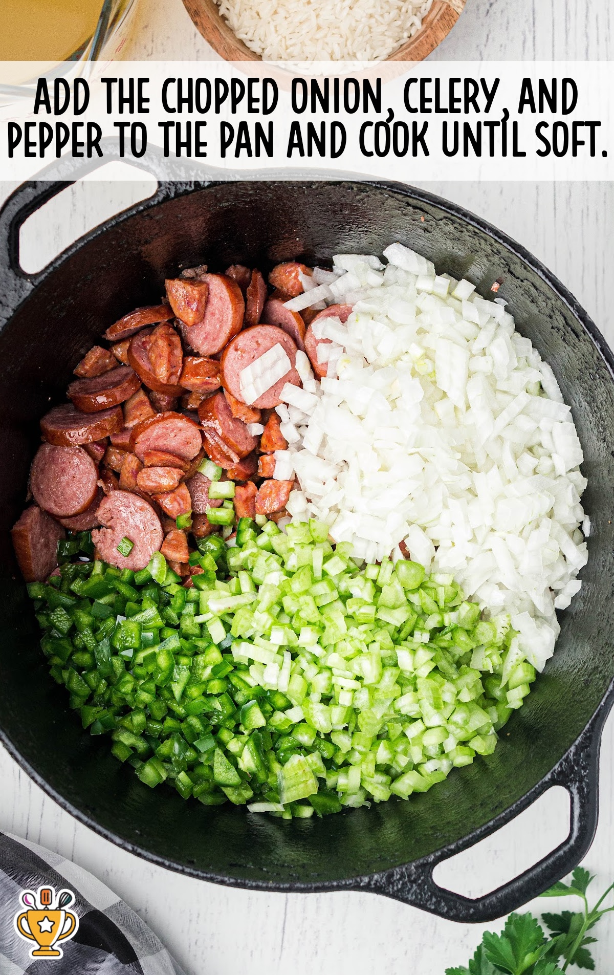 Chopped onion, celery, and green pepper added to sausage in skillet, cooking together until vegetables become soft.