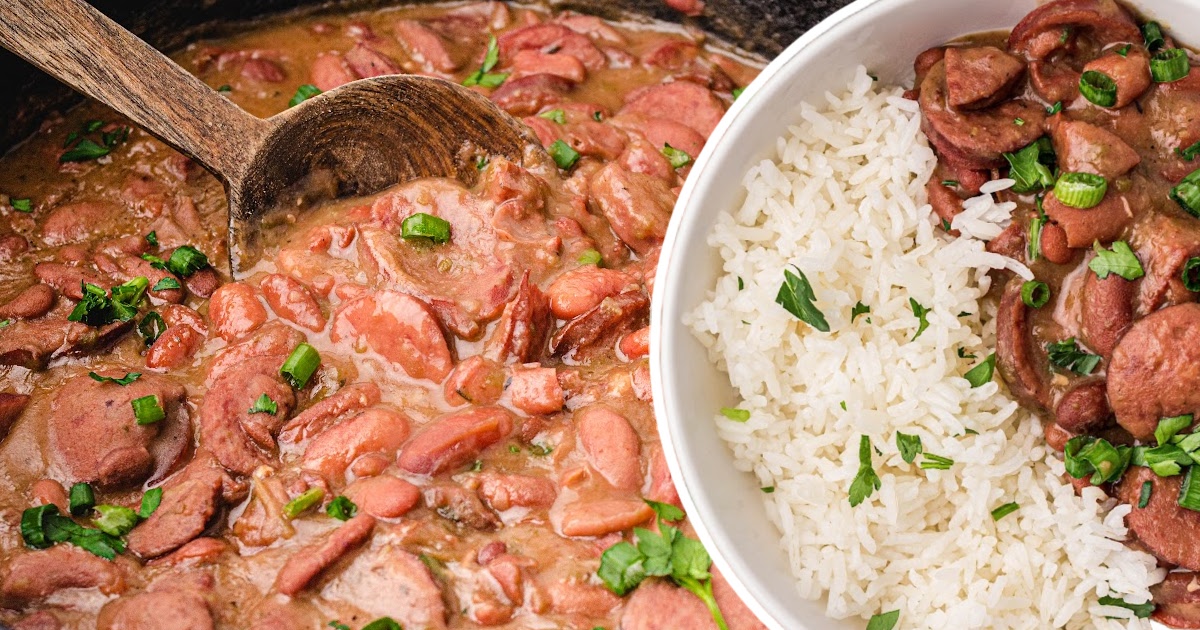 Close-up of red beans and sausage being scooped from a Dutch oven with a wooden spoon, served with fluffy white rice.