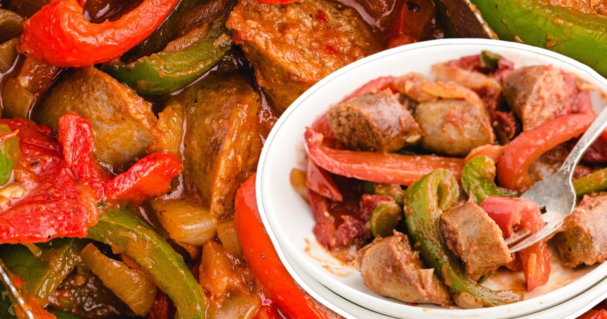 A skillet filled with sausage and peppers, showing vibrant red and green peppers mixed with savory sausage chunks.