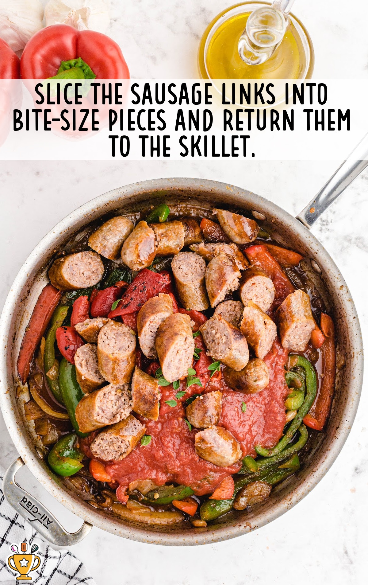 Roasted bell peppers and crushed tomatoes are being added to the skillet. The vegetables are nestled in the sauce, with fresh herbs on top to add flavor.