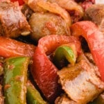 Pin of sausage and peppers, showing a close-up of the dish with juicy sausage links and red peppers.