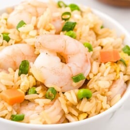 a close up photo pf Shrimp Fried Rice in a white bowl