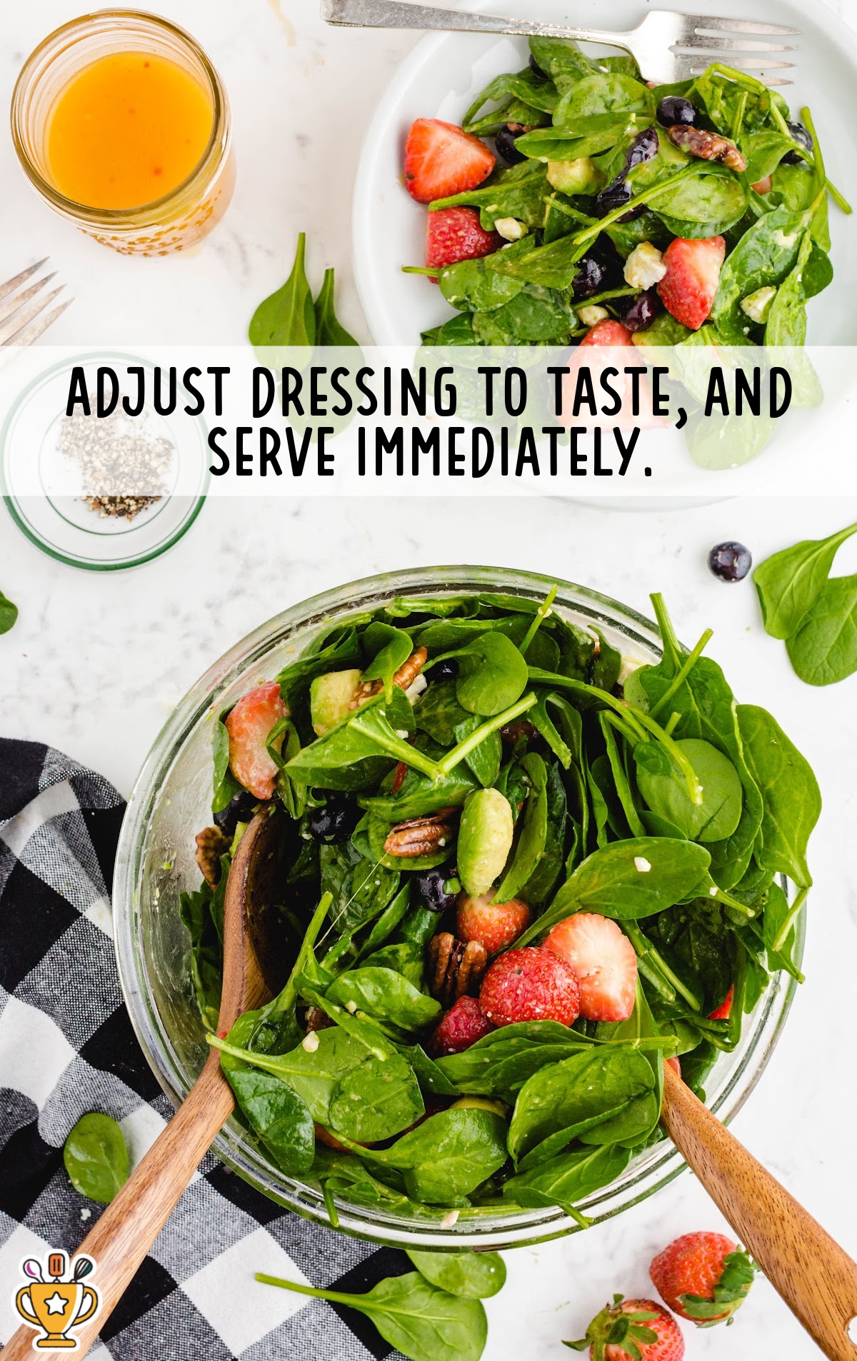 A photo of the final step in preparing the strawberry spinach salad, with dressing being poured over the salad before mixing it all together.