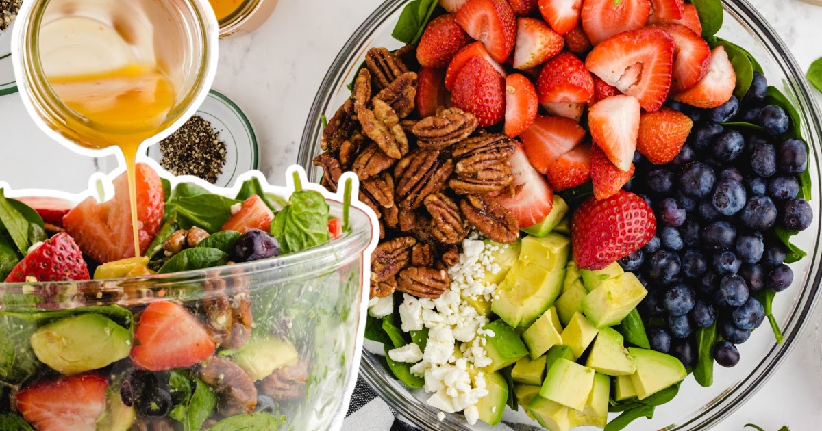 A close-up view of a strawberry spinach salad with ingredients like strawberries, spinach, and avocado, ideal for a fresh and healthy meal.