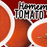 A vibrant shot of creamy homemade tomato soup served in a white bowl, garnished with basil leaves, next to a spoon and crackers.