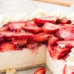 A slice of strawberry cream cheese pie with fresh whipped cream and sliced strawberries, perfect for summer desserts.