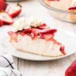 Recipe card with ingredients and instructions for making strawberry cream cheese pie, with strawberries and whipped cream.