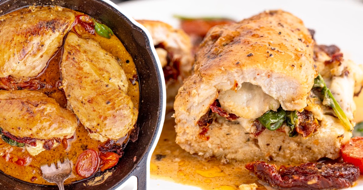 A shot of chicken breast, stuffed with sun-dried tomatoes, spinach, and cheese, served with juicy tomatoes and a golden sauce.