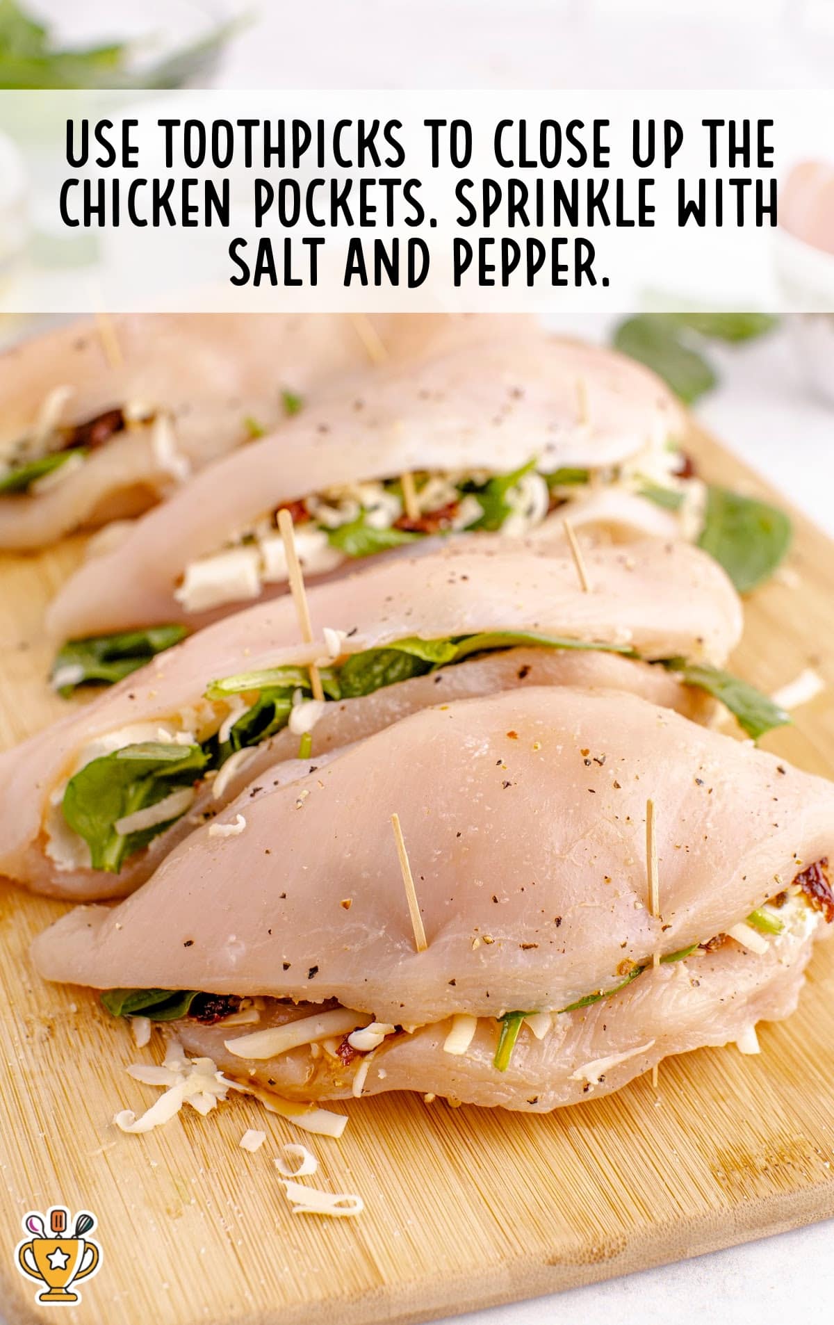 Chicken breasts with a stuffing of spinach, sun-dried tomatoes, cream cheese, and mozzarella, ready to be closed and seasoned.