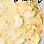 Close-up of cheesy zucchini gratin baked in a skillet with browned melted cheese on top. Text overlay reads “How to make zucchini gratin with a creamy cheese sauce.