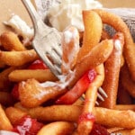 Vertical Pinterest image showing funnel cake fries covered in whipped cream and strawberry glaze with the words "Super Fun & Delicious!"