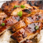 Close-up of sliced Huli Huli chicken served over rice and topped with green onions, with a can of pineapple juice in the corner. Bold text reads “Ultra Juicy Chicken Dinner!”