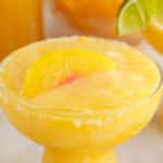 a half photo of peach margarita in a glass