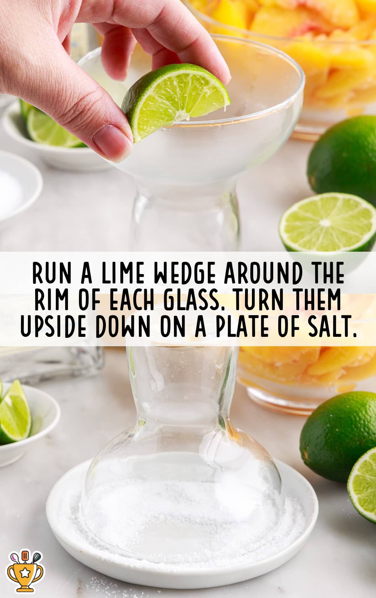 a hand placing a lime wedge around the rim of the glass