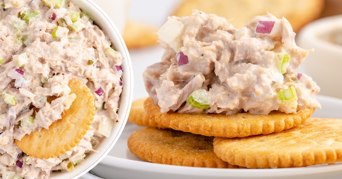Side-by-side image of tuna salad in a bowl and spooned onto round crackers, featuring visible diced red onions and celery.