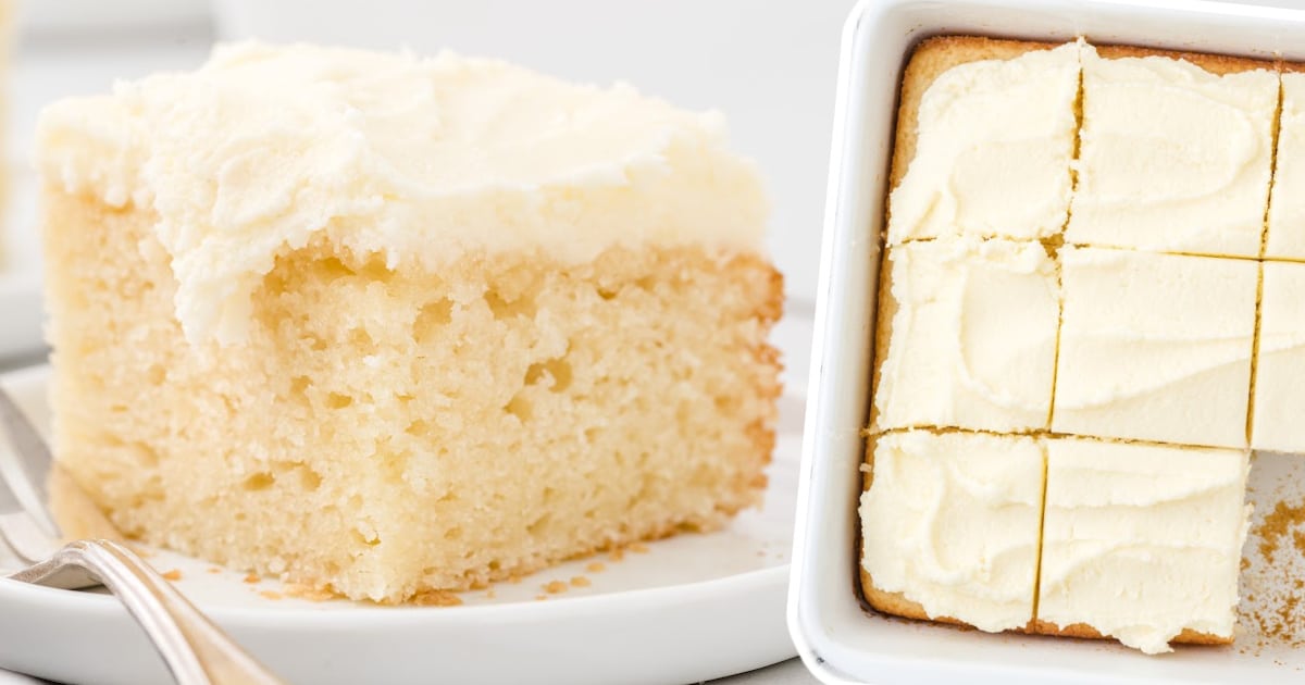 A full vanilla snack cake in the baking pan with a corner slice removed