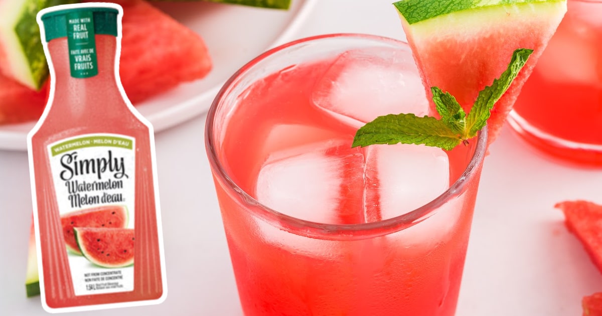 Close-up of a watermelon cocktail in a glass, filled with ice and garnished with fresh mint and a juicy watermelon wedge.