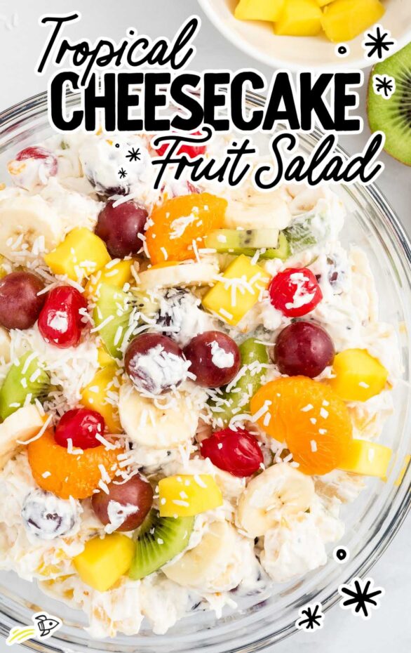 Tropical cheesecake fruit salad with pineapple, mango, kiwi, and creamy cheesecake filling in a glass bowl