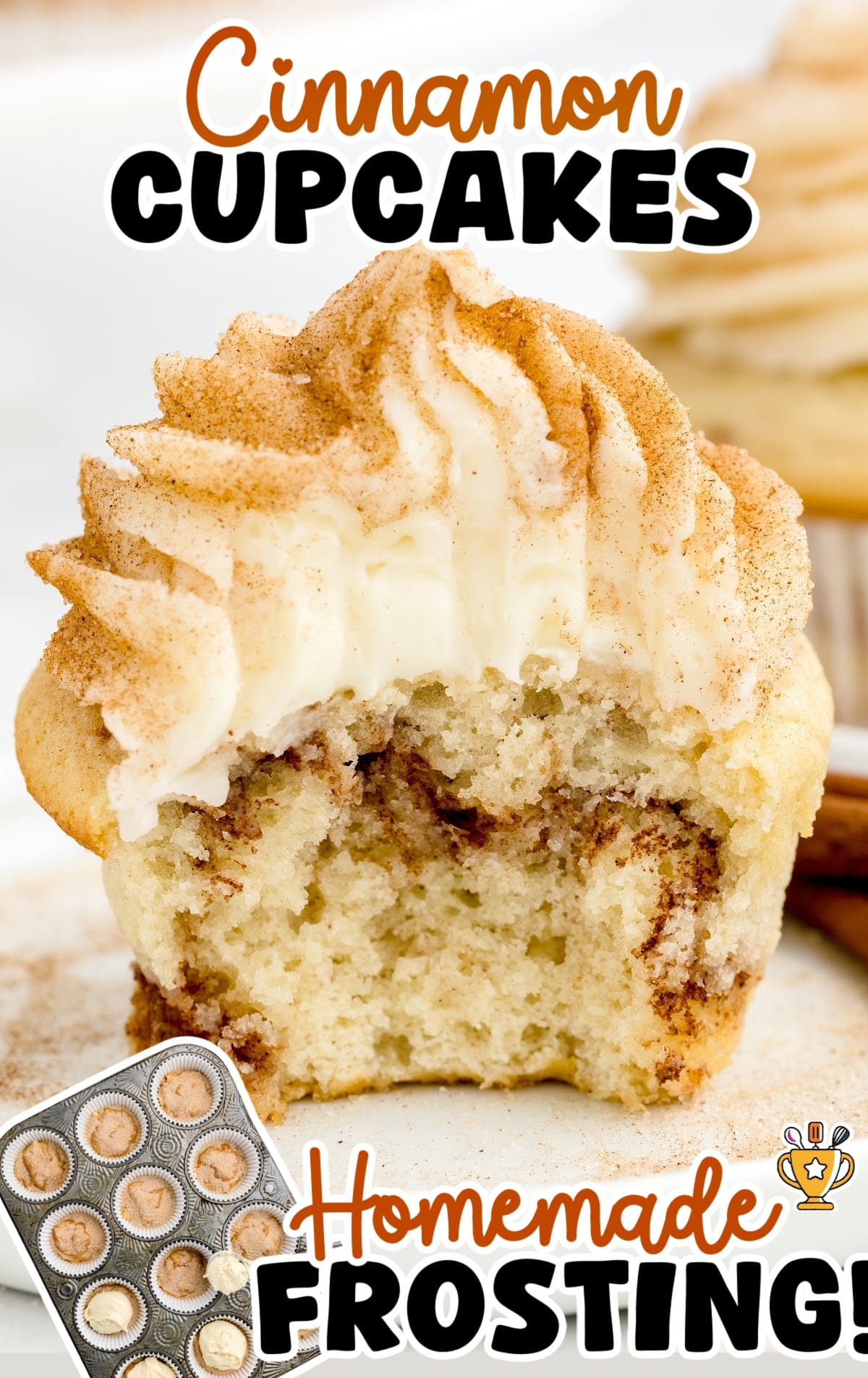 Partially eaten cinnamon cupcake showing a moist, fluffy center with a swirl of cinnamon sugar inside. The cupcake is topped with thick homemade frosting sprinkled with cinnamon. Text overlay reads “Cinnamon Cupcakes Homemade Frosting” with a cupcake tin graphic in the corner.