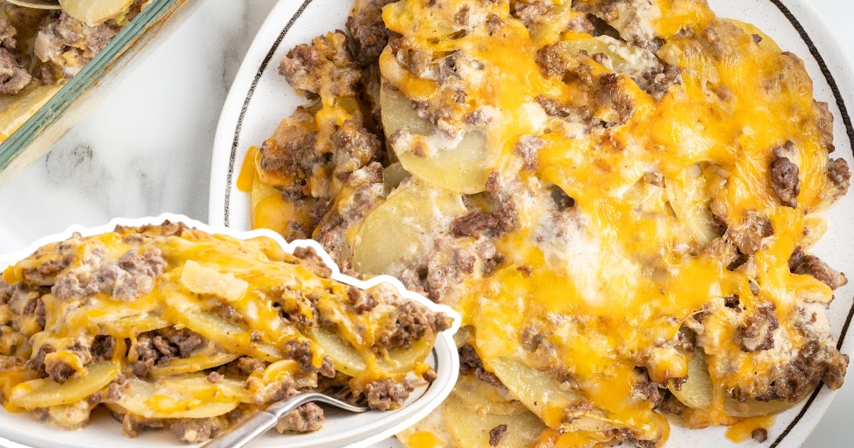 Close-up of cheesy hamburger potato casserole with golden layers of beef, potatoes, and cheese on a white plate.